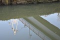 reflection of a bridge in a standing water channel Royalty Free Stock Photo