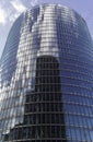 Reflection of a building in the glass windows of a skyscraper and clouds