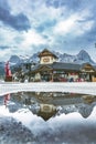 Reflection of a building with mountains in a puddle in the Village Square in Canmore, Alberta Royalty Free Stock Photo