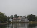 New England Waterfront Homes Reflected on Calm Bay in Overcast Light Royalty Free Stock Photo