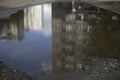 Reflection of building in puddle. Puddle in city. Reflection of house in water Royalty Free Stock Photo