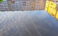 Reflection of the building and the sky in a large puddle of water in the courtyard Royalty Free Stock Photo