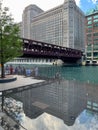 Reflection of buildings into puddle of splash pad on riverwalk Royalty Free Stock Photo