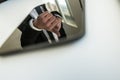 Reflection of a businessman with thumbs up in a tablet PC