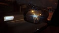 Reflection in car rear mirror while driving at night, POV