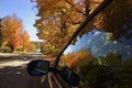 The reflection from the car window of the landscape of mountain road with autumn leaf color Royalty Free Stock Photo