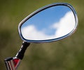 Reflection of clouds on a blue sky in a motobike mirror Royalty Free Stock Photo