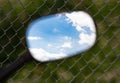 Reflection of clouds on a blue sky in a motobike mirror Royalty Free Stock Photo