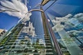 Reflection of the clouds of a blue and white sky in the round glass facade of a modern high-rise building in Hafen City Royalty Free Stock Photo