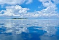 Reflection of clouds on calm and tranquil ocean