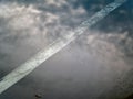 Reflection of the clouds and sky on the flood puddle on the road Royalty Free Stock Photo