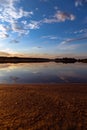 Reflection of clouds and twilight sky over the clear water surface, vertical shot Royalty Free Stock Photo