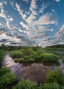Reflection of clouds in the water. Early morning on the Ugra river. Panorama