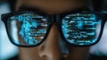 Reflection of computer code in programmer& x27;s glasses Royalty Free Stock Photo