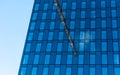 Reflection of a construction crane in the windows of a high rise building Royalty Free Stock Photo