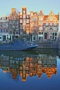 Reflection of crooked and colorful heritage buildings along Prinsengracht Canal and next to Brouwersgracht Canal, Amsterdam Royalty Free Stock Photo