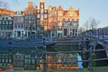 Reflection of crooked and colorful heritage buildings along Prinsengracht Canal and next to Brouwersgracht Canal