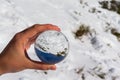 Reflection in a crystal ball of a mountain landscape with snow on a sunny day and blue sky. Royalty Free Stock Photo