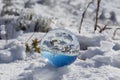 Reflection in a crystal ball of a mountain landscape with snow on a sunny day and blue sky. Royalty Free Stock Photo