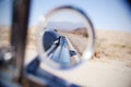 Reflection of desert highway in a car wing mirror Royalty Free Stock Photo