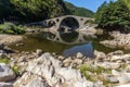 Reflection of Devil's Bridge and Rhodopes mountain in Arda river, Bulgaria Royalty Free Stock Photo