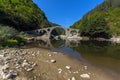 Reflection of Devil's Bridge and Rhodopes mountain in Arda river, Bulgaria Royalty Free Stock Photo