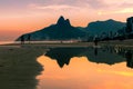 Reflection in water of Dois IrmÃÂ£os Two Brothers mountains on Ipanema beach at sunset in Rio de Janeiro, Brazil, South America