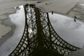 Reflection of Eiffel tower in a puddle in Paris France.