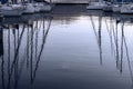 Reflection of the evening sky and the masts of yachts moored off the shore on Lake Garda in Italy Royalty Free Stock Photo