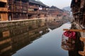 Reflection of farmhouses in water rural river, Zhaoxing, Guizhou, China.