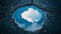 Reflection of a fluffy white cloud in a dark puddle on rough asphalt surface Sky Royalty Free Stock Photo
