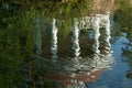 Reflection of the gazebo on the water surface of the pond. Royalty Free Stock Photo
