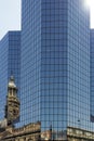 Reflection in glass wall of modern office building