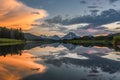Reflection of Grand Tetons in Jackson Lake at sunset with beautiful clouds
