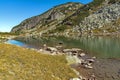 Reflection of green hills in small Lake, Rila Mountain