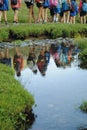 Reflection of a group of mountaineers on the river