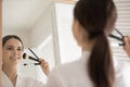 Reflection of happy teen girl applying foundation, powder, blush Royalty Free Stock Photo