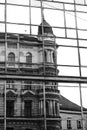 A reflection of a historic Art Nouveau apartment building in a modern glass building in Prague. bw Royalty Free Stock Photo