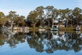 The reflection of house boats and tree on a calm river murray located in the river land at Berri South Australia on 20th June 2020 Royalty Free Stock Photo