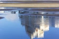 Reflection of a house in a puddle in sunny weather. Early spring Royalty Free Stock Photo