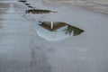 Reflection of a house in a water puddle after a rain storm Royalty Free Stock Photo