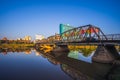 Reflection of Iron Bridge and colorful light lantern in sunrise. Loi Krathong or Yi Peng Festival in Chiang Mai, Thailand Royalty Free Stock Photo