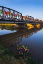 Reflection of Iron Bridge and colorful light lantern in sunrise. Loi Krathong or Yi Peng Festival in Chiang Mai, Thailand Royalty Free Stock Photo