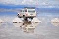 Reflection of jeep in flooded Salar de Uyuni