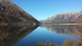 Mountain reflection on lake water in Arthurs Pass, New Zealand Royalty Free Stock Photo