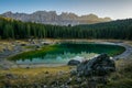 Reflection of Latemar in the clear water of Lake Carezza Karersee in Dolomite Alps, Trentino Alto Adige, South Tirol, Italy