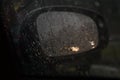 Reflection of lights in a car`s side mirror on a rainy night Royalty Free Stock Photo