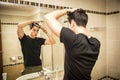 Reflection of Man Bushing Hair in Mirror Royalty Free Stock Photo