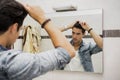 Reflection of Man Bushing Hair in Mirror Royalty Free Stock Photo