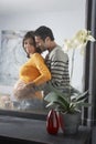 Reflection Of Man Embracing Pregnant Woman